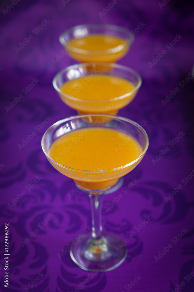 Peach jelly on vibrant violet background Peach jelly on vibrant violet background
