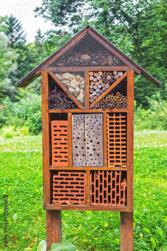 Fototapeta Naklejka Na Ścianę i Meble -  Insects hotel – construction made of natural materials and components used as a shelter and nest for bugs and bees in a garden