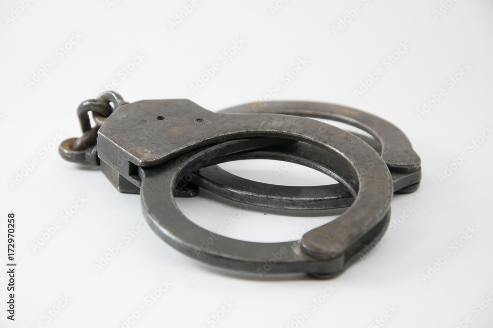 Old Police handcuffs isolated on white background Old Police handcuffs isolated on white background