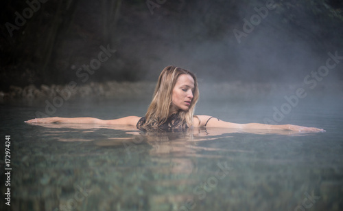 Fototapeta Naklejka Na Ścianę i Meble -  Young Woman Taking a Bath In Hot Spring Outdoor Maibachl Villach Austria