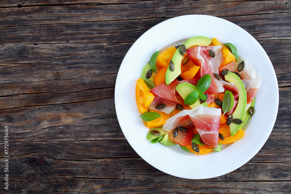 salad with ham, tomato, pumpkin seeds, avocado