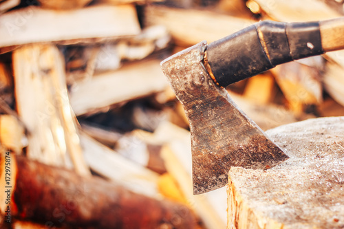 closeup old ax on firewood background