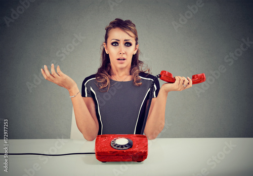 Tableau sur toile Shocked young woman receiving bad news on the phone