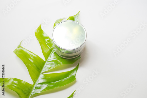 natural cosmetics bottle containers with green leaf on white background,natural beauty skincare product,  beauty product concept