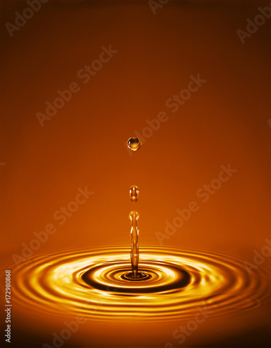 Wallpaper Mural Droplet with ripples in gold amber liquid Torontodigital.ca