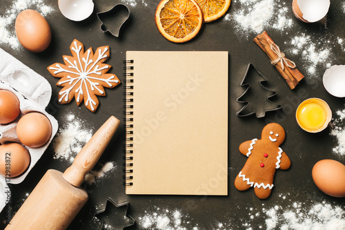 Xmas baking or cooking background. Ingredients, kitchen items for baking cookies. Kitchen utensils, flour, eggs and sugar. Text space, top view.