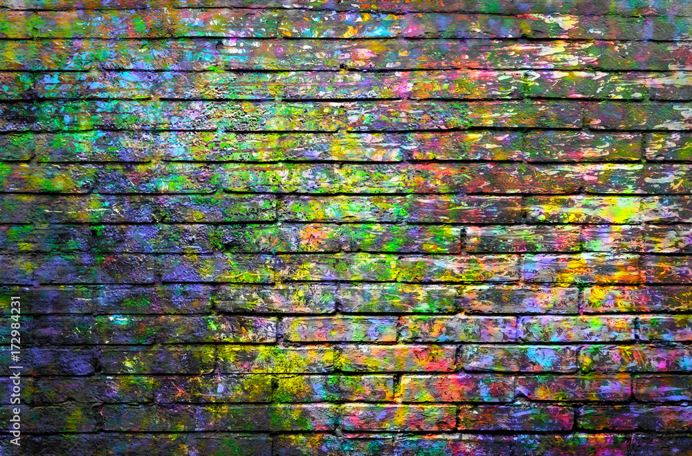 Brick wall painted with spots of paint colors 