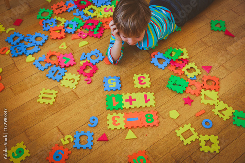 little boy playing with puzzle, education concept