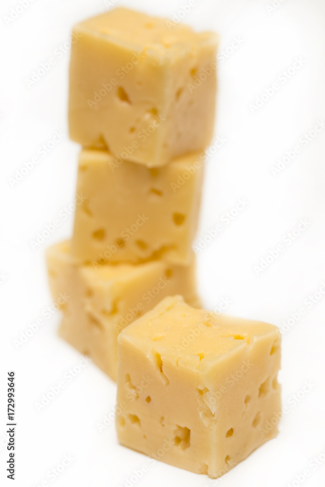 Cube of cheese isolated on a white background Cube of cheese isolated on a white background
