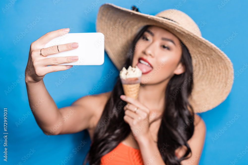 Fototapeta premium Woman taking selfie with ice-cream