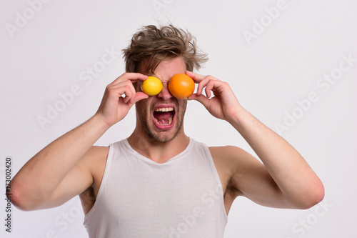 Athlete with messy hair holds fresh fruit. Man with fruit © be free