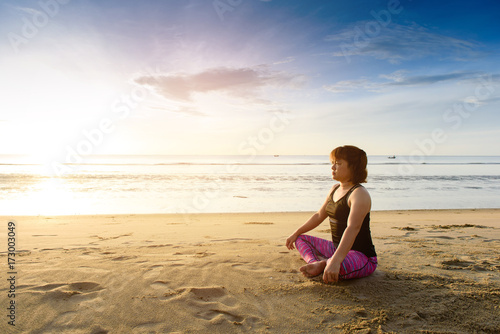 Woman yoga on the beach