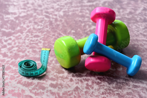Shaping and fitness equipment. Barbells in green, pink and cyan