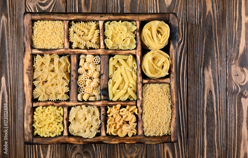 Traditional types and shapes of Italian pasta in vintage wooden box