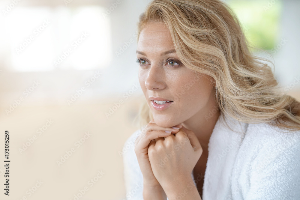 Portrait of beautiful 40-year-old woman relaxing in bathrobe at home Portrait of beautiful 40-year-old woman relaxing in bathrobe at home
