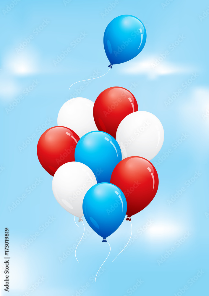 Red, white and blue balloons floating in a cloudy sky
