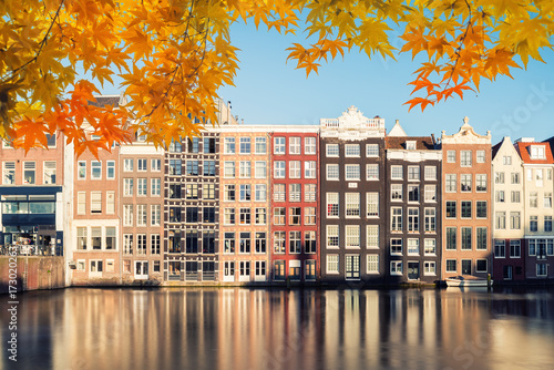 Autumn season at Amsterdam street traditional ancient dutch colorful buildings with canal in Amsterdam, Netherlands.