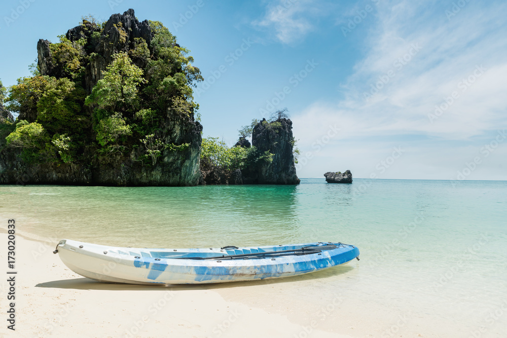 Blue kayaks on the tropical beach in Phuket, Thailand. Summer, Vacation and Travel concept. Blue kayaks on the tropical beach in Phuket, Thailand. Summer, Vacation and Travel concept.