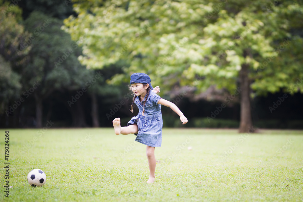 Happy Little Girl Kicking Soccer Ball Happy Little Girl Kicking Soccer Ball
