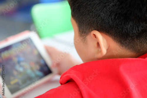 Asian child Boy are addictive playing tablet and mobile phones, Game Addiction