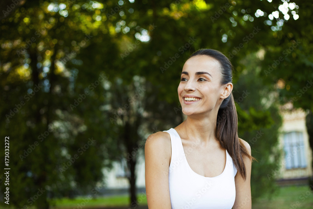 Portrait of a young beautiful brunette woman in park. Portrait of a young beautiful brunette woman in park.