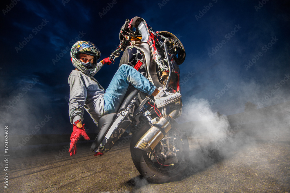 Free Photo  Moto rider making a stunt on his motorbike biker