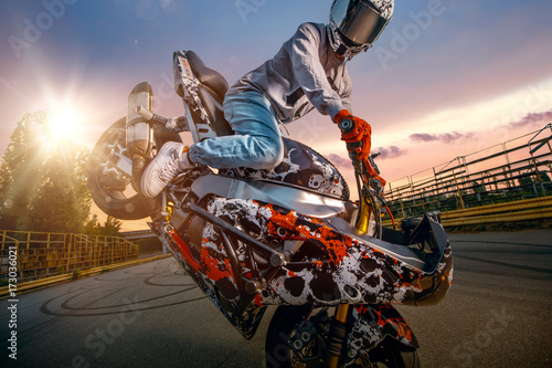 Moto rider making a stunt o...