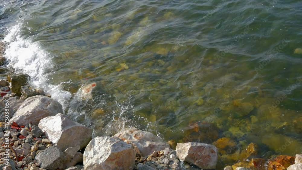 Waves splashing on stones at seashore. Shot in slow-motion hd Waves splashing on stones at seashore. Shot in slow-motion hd