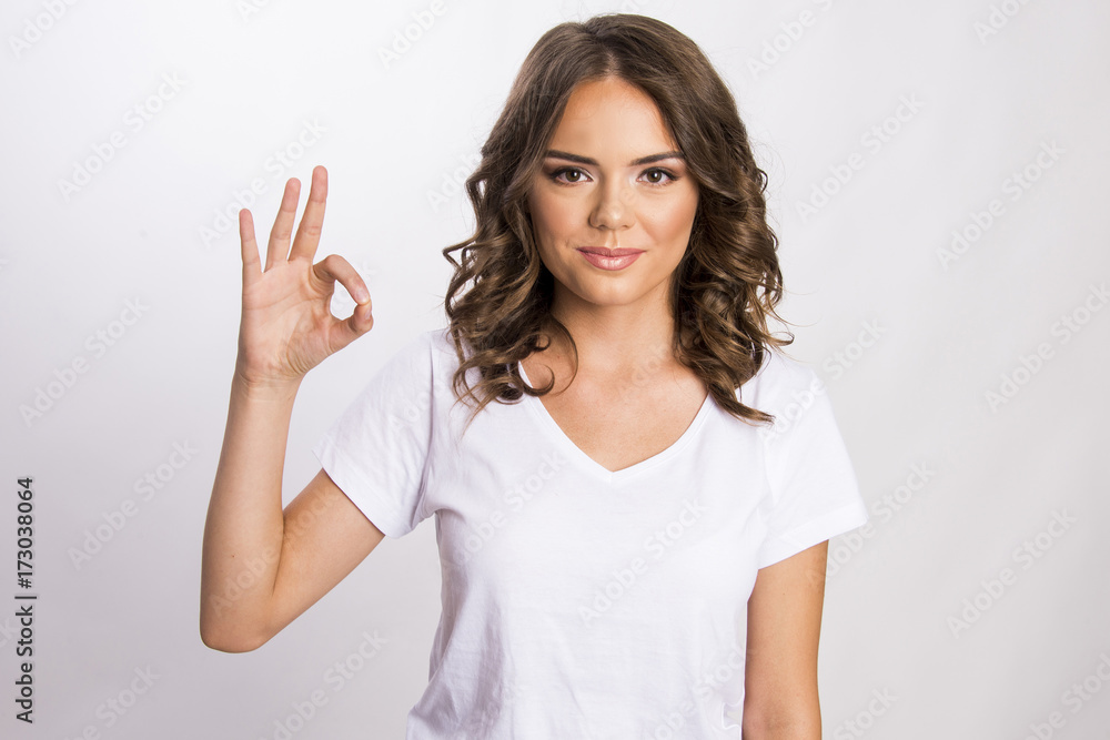 Portrait of a beautiful young girl showing good sign with thumbs isolated on white, body gesture Portrait of a beautiful young girl showing good sign with thumbs isolated on white, body gesture