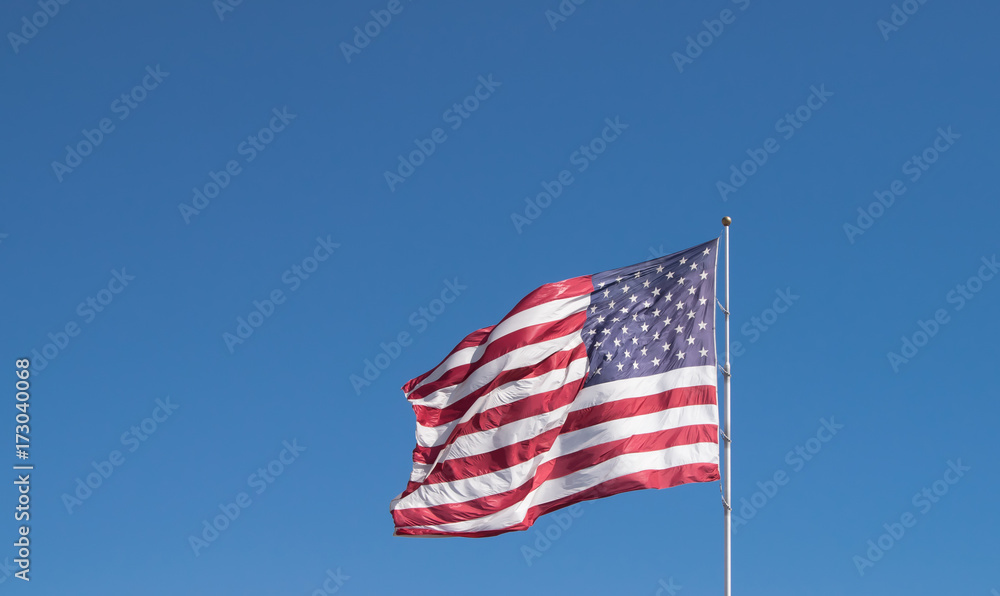 American Flag flying against blue sky