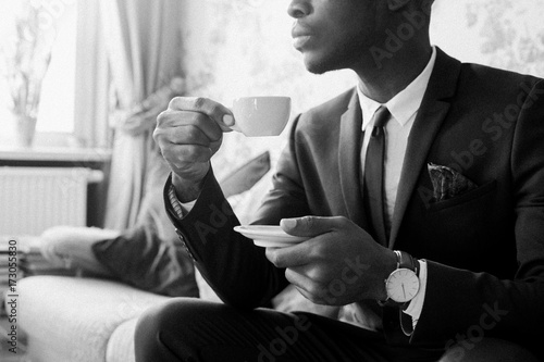 Black and White Portrait of Young Black Man Drinking Espresso