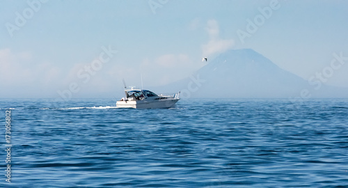 Sport fisher passing front of St Augstine Volcano