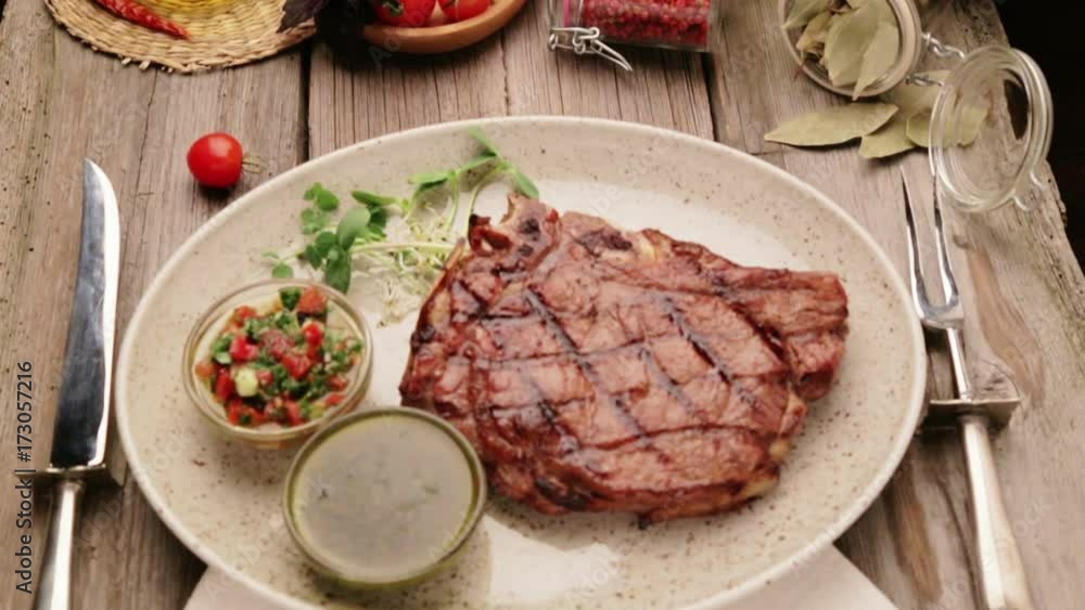 Composition with steak and spices on a plate. The beef steak is beautifully decorated in the restaurant. Correctly fried steak with sauces.
Composition with steak and spices on a plate. The beef steak is beautifully decorated in the restaurant. Correctly fried steak with sauces.