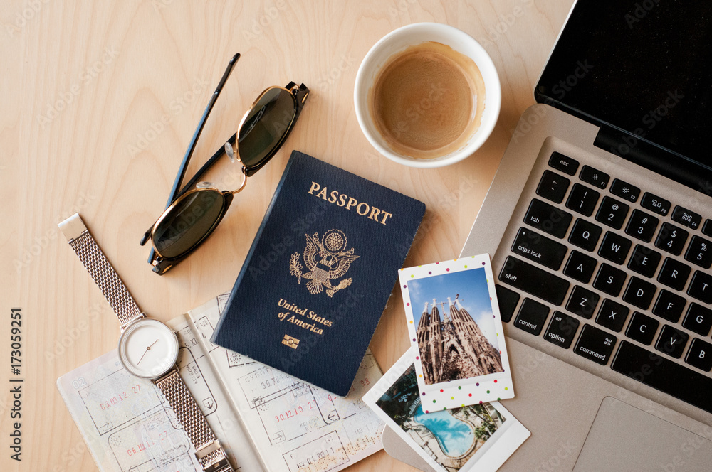 Office desk with a laptop, passports, Polaroid pictures and coffee Office desk with a laptop, passports, Polaroid pictures and coffee