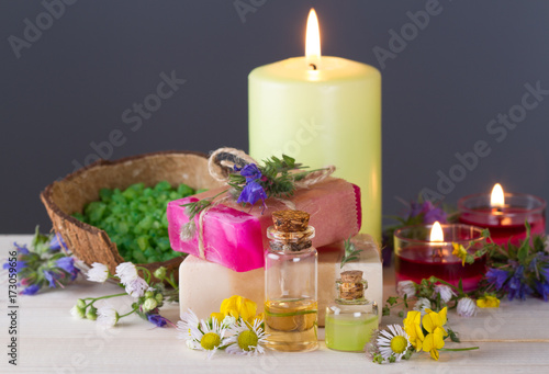 Essentials oils, burning candles,handmade soap,sea salt and grass blossoms.Spa concept photo