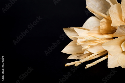 Fototapeta Naklejka Na Ścianę i Meble -  Kind of wood flower isolated on black background; to be placed on the site of cremation in Thailand. (Dok Mai Jan)