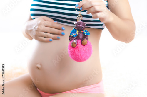 pregnant woman with baby pink toy