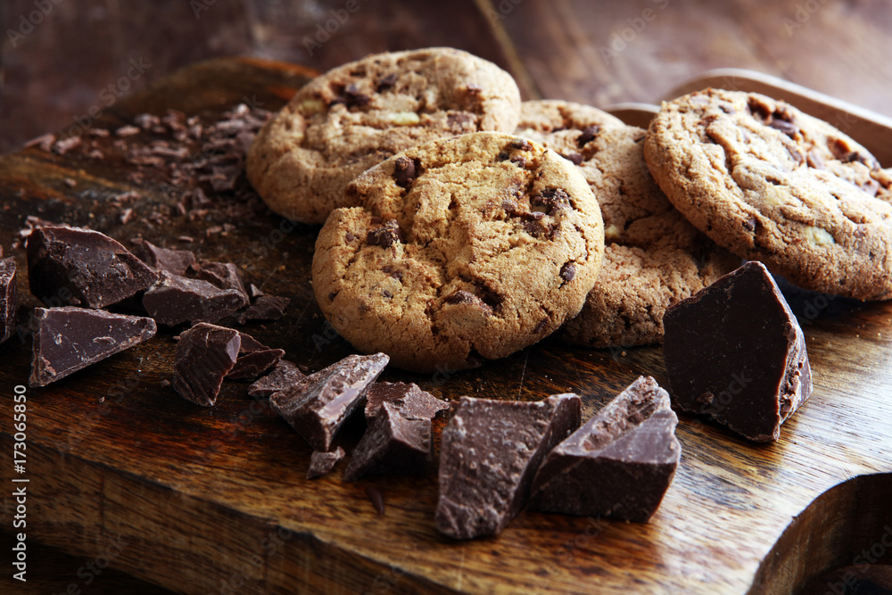 Fototapeta premium Chocolate cookies on wooden table. Chocolate chip cookies shot