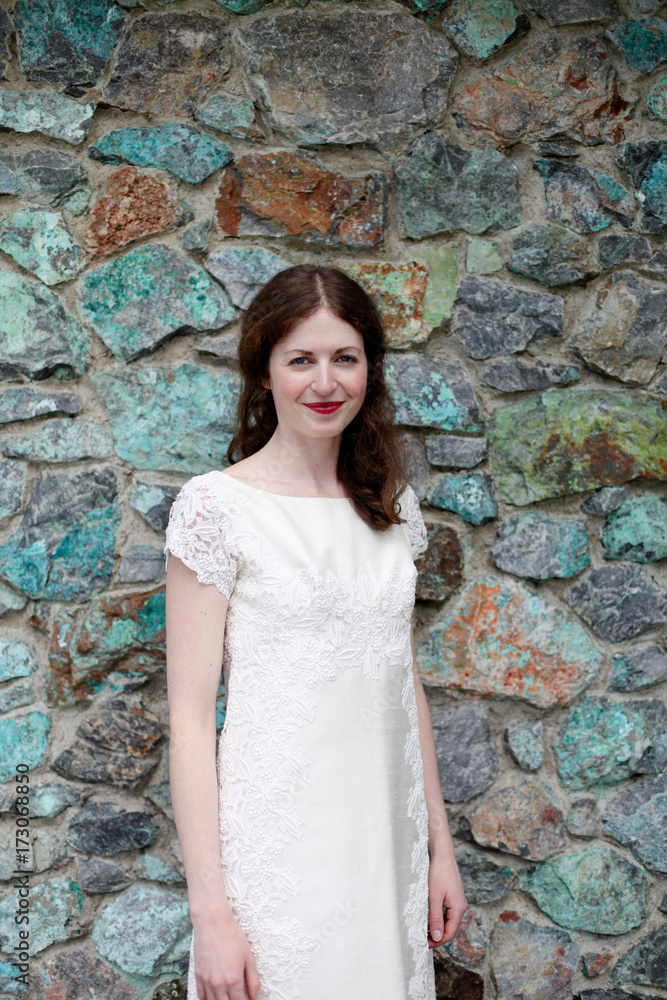 Beautiful bride in front of stone wall Beautiful bride in front of stone wall