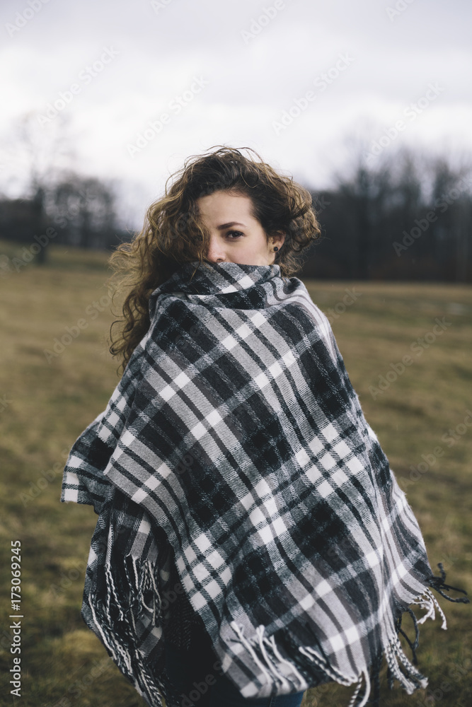 Portrait of young woman wearing a poncho, outdoors Portrait of young woman wearing a poncho, outdoors
