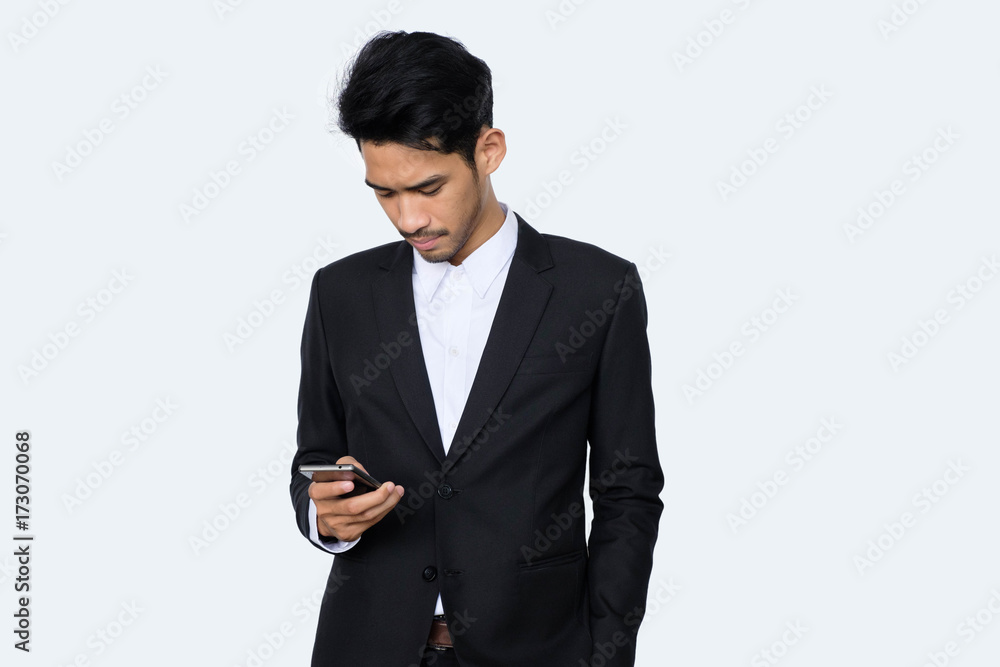 Young handsome asian business man using smartphone contact with partner while standing isolated white background,business people concept Young handsome asian business man using smartphone contact with partner while standing isolated white background,business people concept