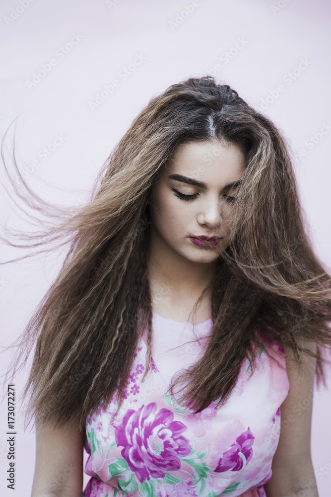 Portrait of a young woman wearing a pastel dress Portrait of a young woman wearing a pastel dress