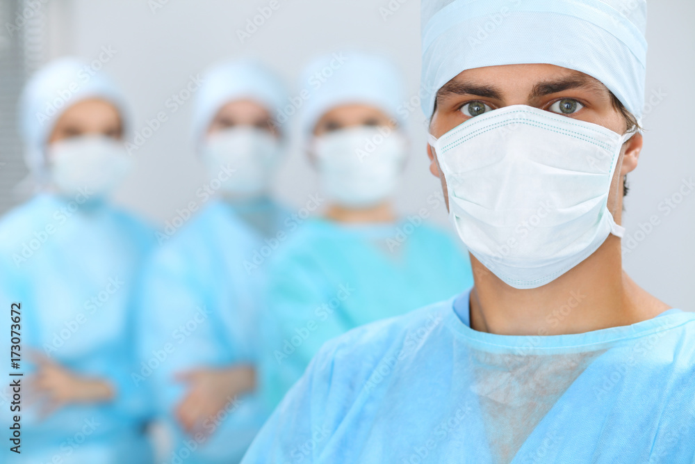 Medical team performing operation. Focus at male doctor Medical team performing operation. Focus at male doctor