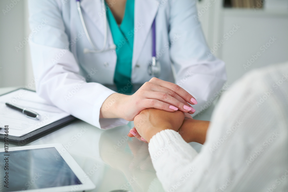 Doctor and patient, close-up of hands. Physician talking about medical examination results. Medicine, healthcare and helping concept Doctor and patient, close-up of hands. Physician talking about medical examination results. Medicine, healthcare and helping concept