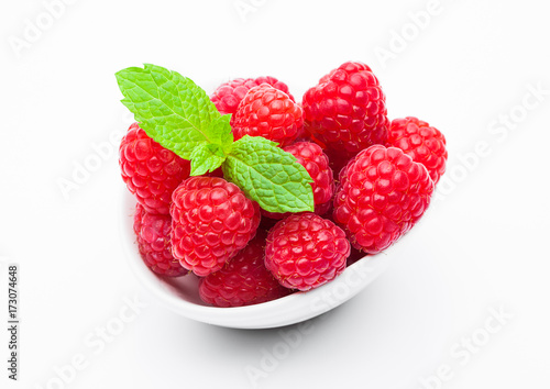 Fresh healthy red raspberries in white bowl