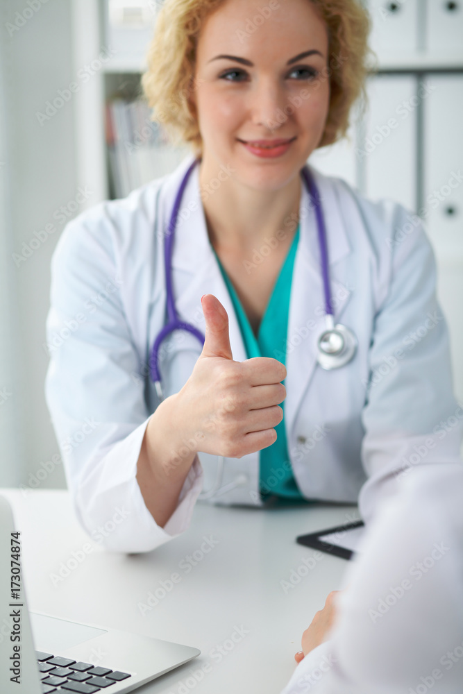 Close up of female doctor thumbs up. Happy cheerful smiling physician ready to examine patient. Medicine, healthcare and help concept Close up of female doctor thumbs up. Happy cheerful smiling physician ready to examine patient. Medicine, healthcare and help concept