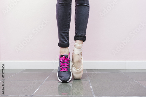 Dancer with dance shoe and sneaker photo