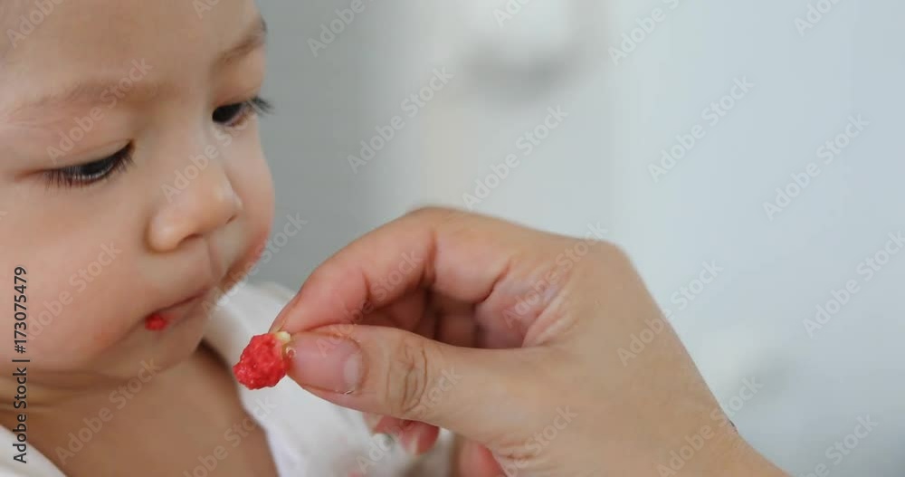 cute asian baby boy happy eating food with mom cute asian baby boy happy eating food with mom