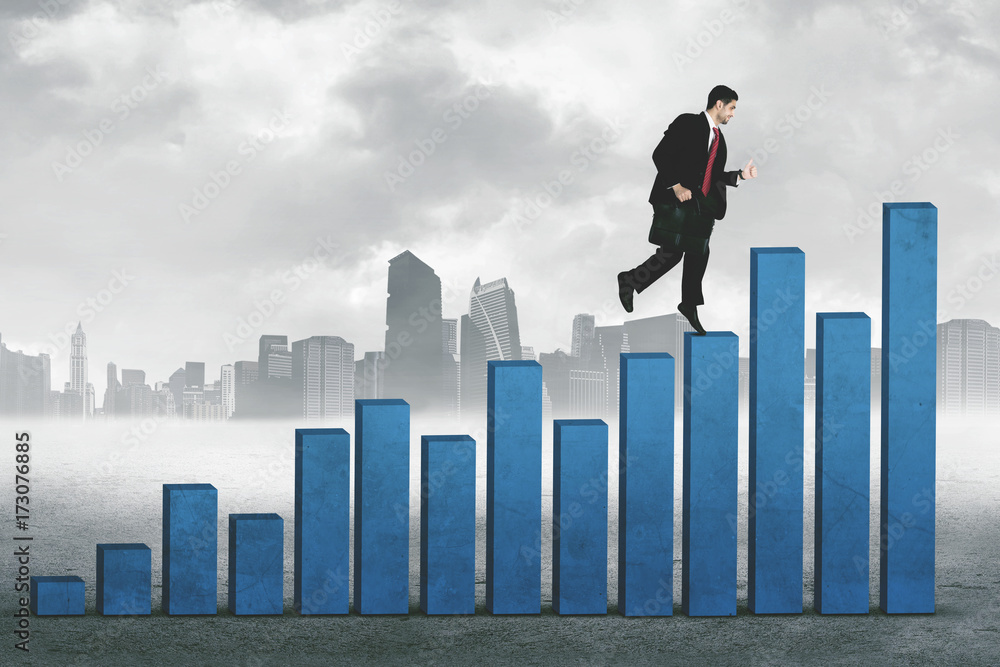 Young manager running over growth graph Young manager running over growth graph
