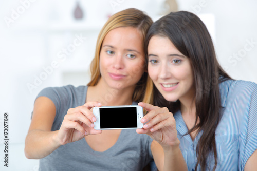happy teenage girls taking selfie